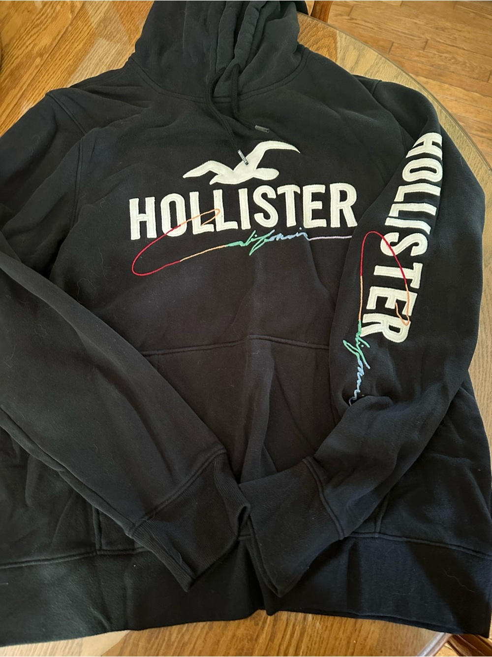 Hollister Black Pullover Hoodie with White Logo and Multicolor Script